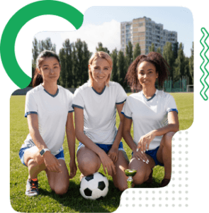 Three sports club players together on a football pitch
